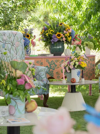 The decor featured a mix of patterns and textures, with floral-print chairs and hand-painted consoles, creating a rich, layered look.