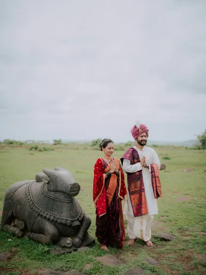 A couple paying respects at a historic site, incorporating cultural elements into their pre-wedding shoot.