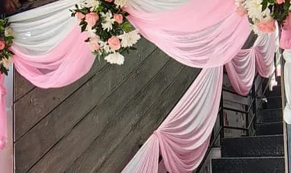We pay attention to every detail, including decorating stairways with drapes and floral accents to create a cohesive look throughout the venue.