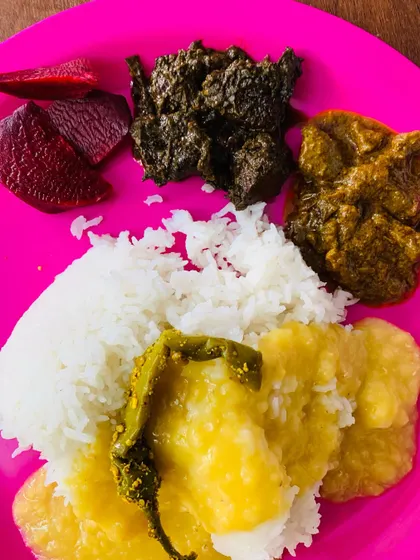 A full view of my plate, with dal and a whole king chilli on top of the rice, served with my homemade beef liver and smoked pork curries.