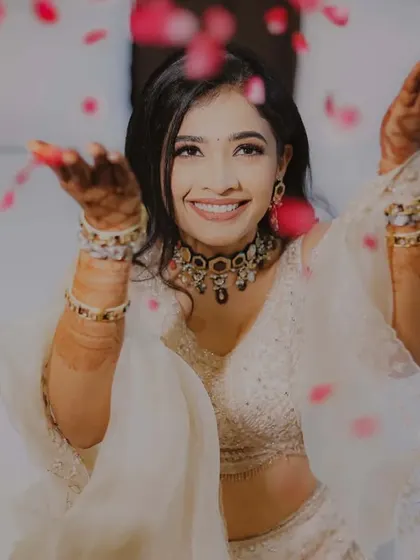 A joyful bride celebrating her engagement. The shower of petals adds a touch of magic to this happy and spontaneous portrait.