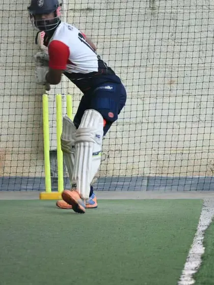 A senior player getting into position to play a shot during a morning session. We focus on maintaining a strong, balanced base for effective stroke play.