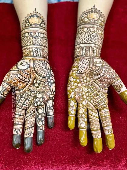 The full view of the engagement mehendi, with matching peacock and lotus motifs on both hands.