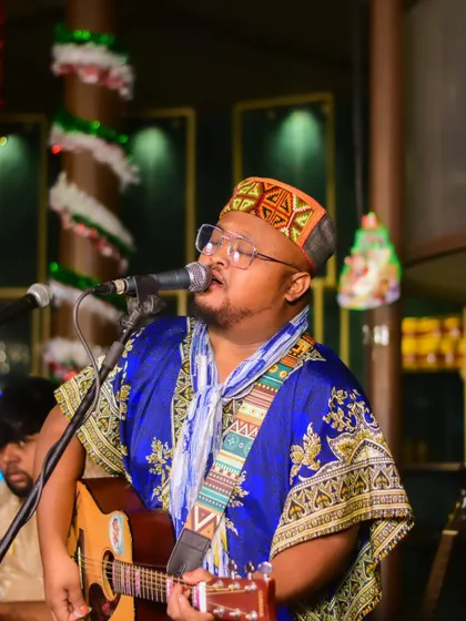 Singing 'Tum Tak' at a Christmas-themed event. The festive decor added a special touch to this soulful performance.