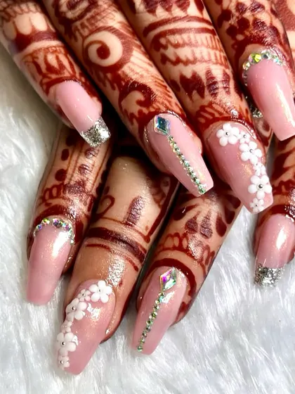A perfect example of my custom bridal work, designed to complement intricate mehndi. This set features a soft pink base, delicate 3D floral accents, and sparkling crystal placements for a look that's both romantic and glamorous.