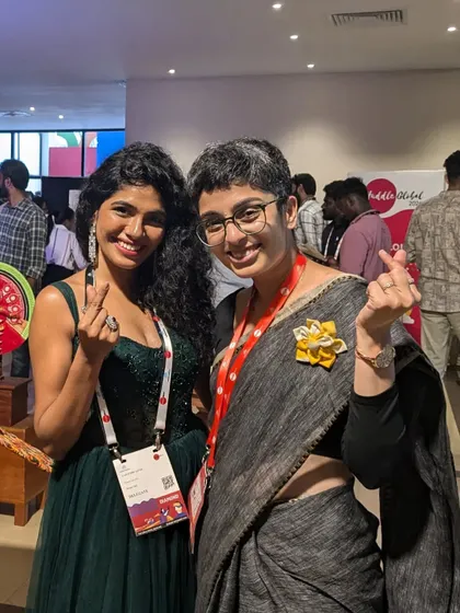 Sharing a moment with an attendee at Huddle Global. My events are designed to be inclusive and fun, breaking away from the stiff, formal vibe of typical corporate conferences.