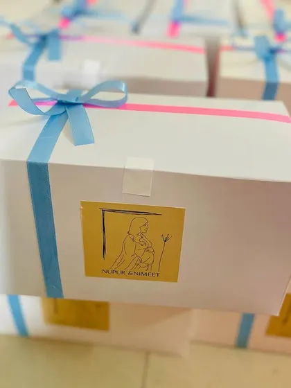 Another view of the custom baby shower hamper boxes, tied with pink and blue ribbons.