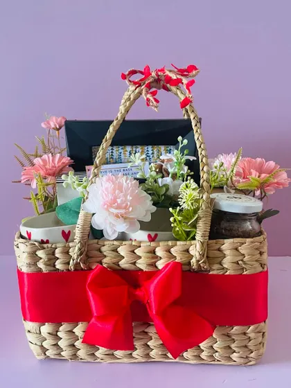 Another angle of the couple's hamper, showing the delicate flowers and the bright red ribbon that ties it all together.