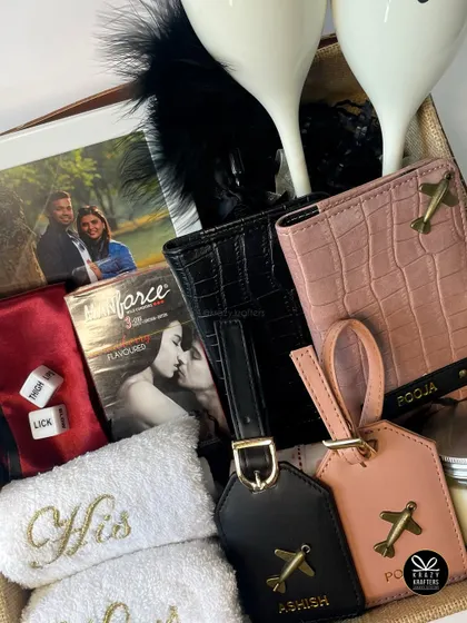 Sweet, spicy, and a little bit naughty. This hamper includes personalized travel gear, 'His & Hers' towels, and some fun, kinky games for a couple's night in.