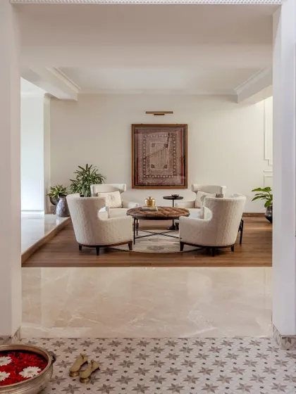 Looking from the foyer into the sunken formal living area. This transition between the tiled floor and the warm wood creates a clear and elegant separation of spaces.