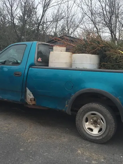 Our "new" old pickup truck, loaded with barrels and Christmas trees for composting. We keep the pickups going no matter what, even when it's freezing cold.