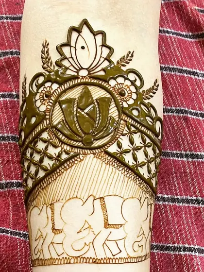 An in-progress shot of an armband design. It features a lotus mandala, intricate jaal work, and a border of elephants, combining several auspicious symbols.