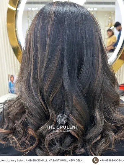 This look is a perfect example of trendy yet timeless hair. The soft curls and subtle highlights create a beautiful, healthy-looking style that's perfect for any occasion.