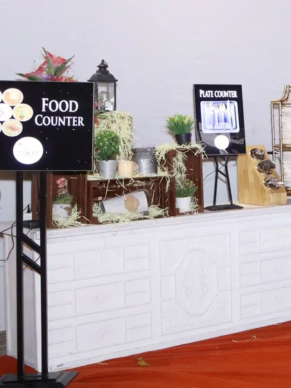 We use modern technology to enhance the guest experience. Here, digital screens clearly label the "Food Counter" and "Plate Counter," making it easy for guests to navigate the buffet.