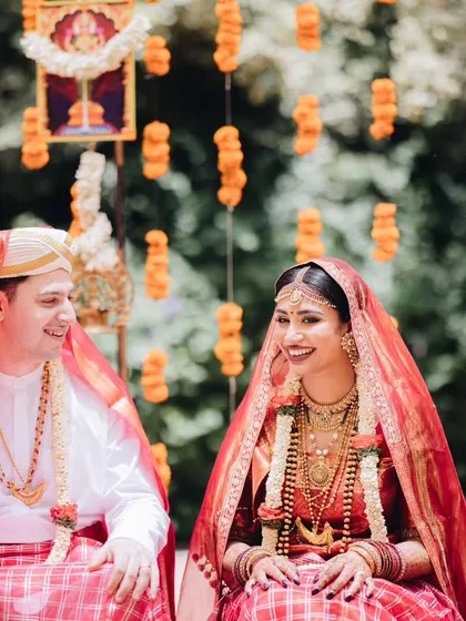 A beautiful portrait of a couple during their traditional Coorgi wedding ceremony, surrounded by decor that honors their heritage.