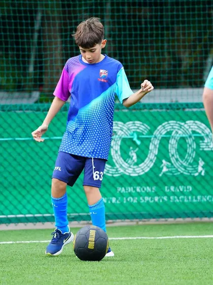 A player practices his ball control with a weighted medicine ball to improve strength and stability.