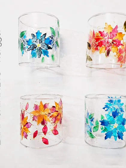 A collection of my floral-painted lamp chimneys. I offer them in different color schemes, like the cool blues and the warm autumn tones seen here.
