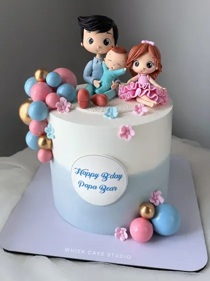 A heartwarming cake for "Papa Bear." This design features a handcrafted family portrait with figurines of a dad and his two children.