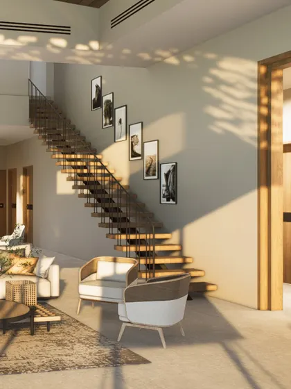 The living area of this Kangra holiday home is designed to be open and airy, with a floating staircase that adds an architectural element without obstructing the view. The palette is warm and minimal.