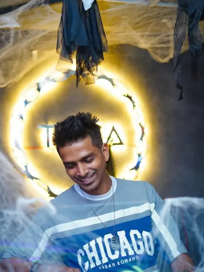 A candid smile during the Halloween week gigs. Even with spooky decor, the vibe is always about joy and music.