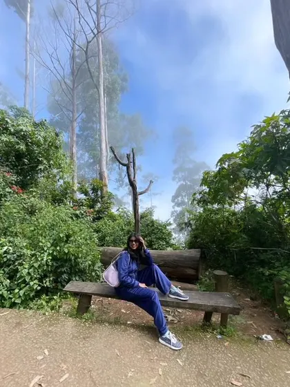 Taking a break on a bench in the Kodaikanal forest. Even on a trek, a well-fitting tracksuit can look put-together and stylish.