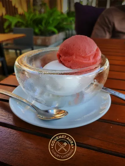 A refreshing scoop of strawberry and lemon sorbet served in a thick glass bowl. A perfect light dessert or palate cleanser.