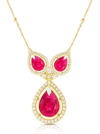A stunning ruby and diamond necklace photographed on a white background, with precise lighting to capture the sparkle of the gems and the shine of the gold.