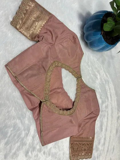 A beautiful nude-peach blouse with a simple gold embroidered border.