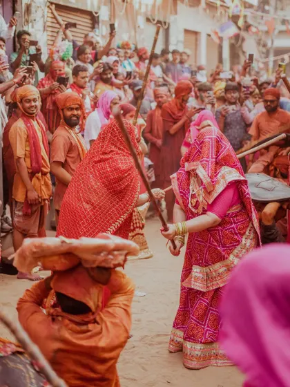 A comprehensive photo series from Lathmaar Holi in Barsana. These images document the unique tradition where women playfully hit men with sticks, recreating a legend of Lord Krishna and Radha. The photos are filled with motion, color, and raw emotion.
