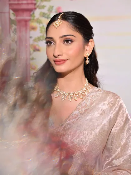 An artistic shot capturing the movement and grace of the bride. The makeup remains flawless, highlighting the dewy skin and soft features.