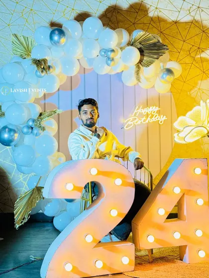 A stylish 24th birthday setup with a cool blue and white theme and marquee numbers.