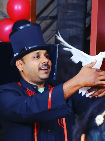 And for the grand surprise, a beautiful white dove appears from thin air. This classic piece of magic always brings a gasp from the audience, making any event, like this one at Isha Cafe, truly memorable.