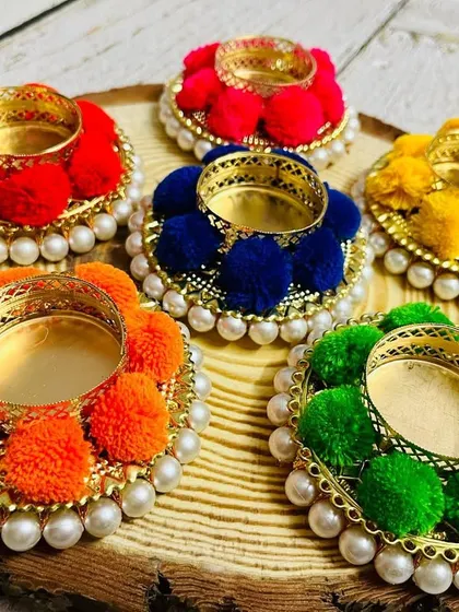 Launching the first product from my Diwali collection: these colorful pom-pom tea light candle holders. They come in a set of assorted colors.