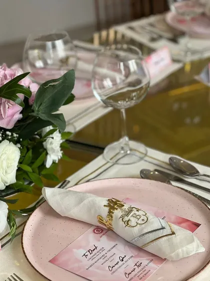 A customized table setting for a special occasion, featuring personalized menus and napkins, demonstrating our ability to tailor every detail to your event.