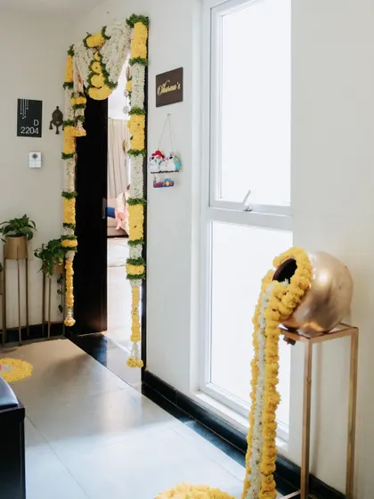 A beautiful housewarming decoration for an apartment entrance. I used traditional marigold and tuberose flower garlands to create an auspicious and welcoming entryway.