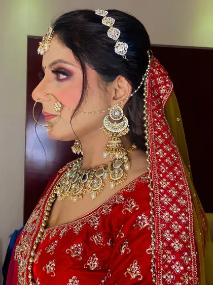 A side profile showcasing the complete bridal look. The hairstyle, makeup, and jewelry all work together to create a cohesive and stunning appearance.