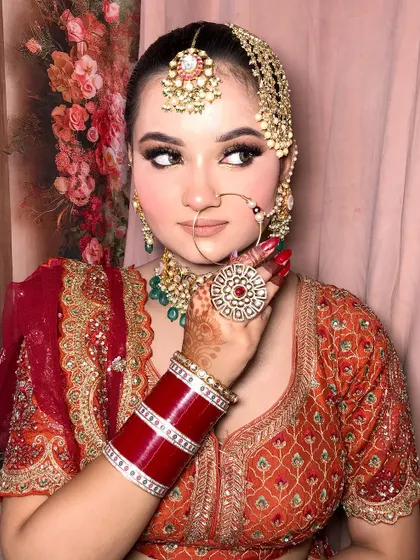 A close-up of the side profile, highlighting the nath and the detailed eye makeup.