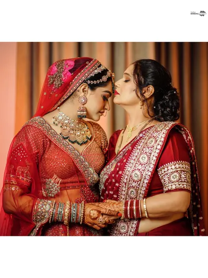 A touching moment between the bride and her mother. A gentle kiss on the forehead is a perfect expression of love and blessings.