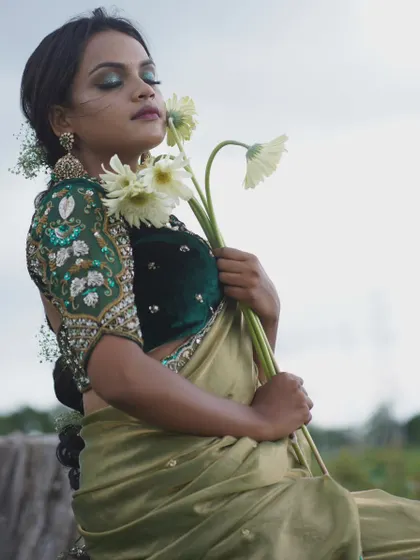 This unique blouse features bird-motif embroidery on the puffed sleeves, set against a dark green velvet body. It’s a perfect example of how I blend traditional motifs with contemporary design for a standout look.