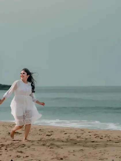 A joyful shot of a couple running along the water's edge. This captures the carefree and happy feeling of being in love.