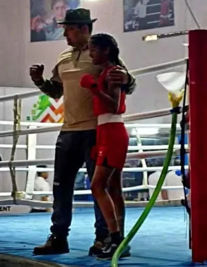 In the heat of a match, a coach's support is vital. Here I am in the corner with my student between rounds, offering encouragement and tactical advice for the next round of her boxing bout.