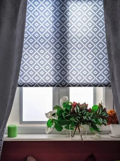 A repeat image of the geometric patterned Roman blind, showcasing its stylish and functional appeal in a cozy home setting.