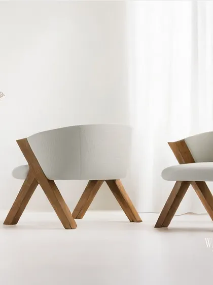 A rear view of my modern wooden accent chairs, showing the distinctive V-shaped leg structure. This design provides stability while creating a strong, sculptural silhouette.