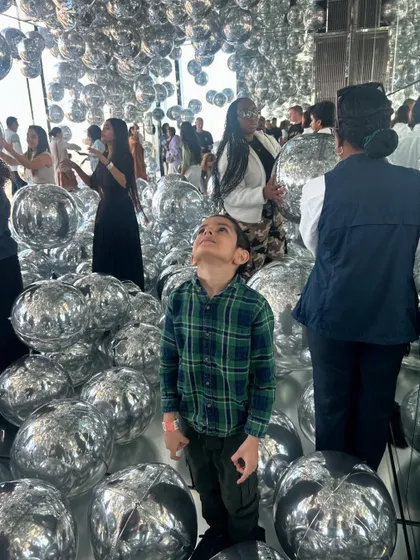 Kai looking up in awe at the 'Air' installation by Kenzo Digital at Summit One Vanderbilt. Immersive, sensory art experiences are a powerful way to inspire wonder and creativity.