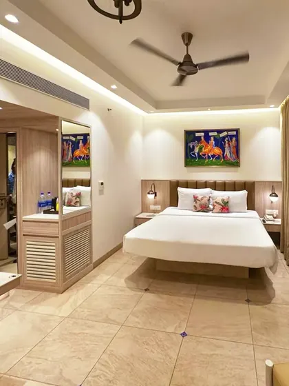 A full view of a guest room at our recently completed project in Candolim, Goa. The room features a floating bed design, clean lines, and a neutral palette accented by colorful local artwork.