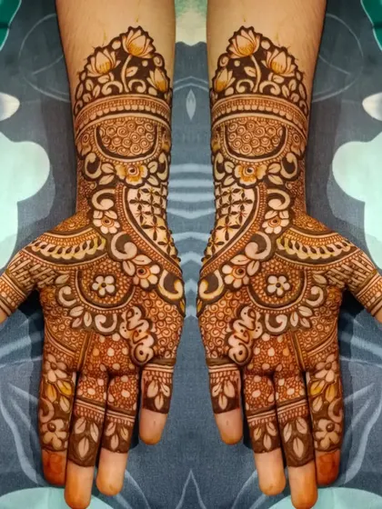 This full-hand design is rich with detail, featuring floral cuffs, intricate swirls, and leafy patterns that extend down to the fingertips.