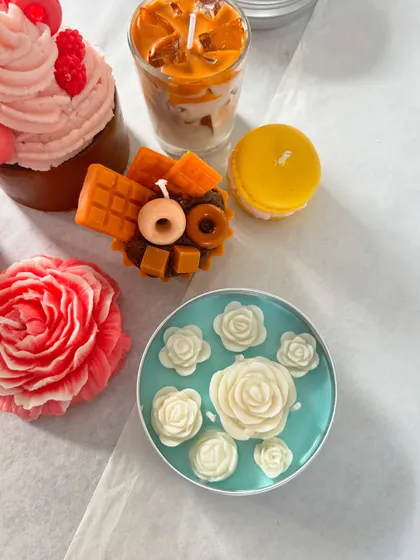 A collection of our intricate dessert and floral candles, showcasing the creative possibilities with wax.