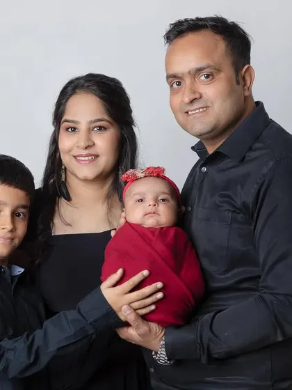 The complete family, including the older brother proudly holding his new baby sister. A heartwarming moment.