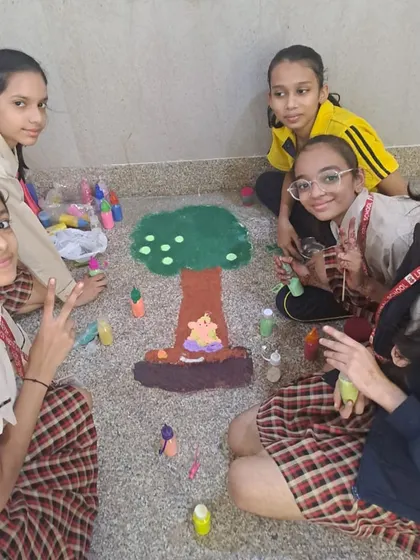 Students collaborate on a rangoli design depicting a tree, blending environmental themes with festive art. We encourage creative thinking that connects different aspects of their learning.