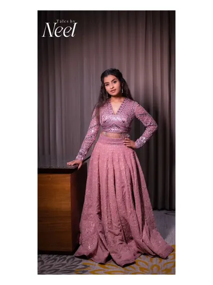 A full-length portrait of Sivaangi, showcasing her complete look for the concert. The modern hairstyle and glamorous lehenga are perfect for a stage performance.